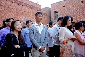 A lively crowd attentively listens to program of speakers.